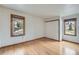 Sunlit bedroom features wood floors and ample closet space with scenic views from the window at 23678 Pondview Pl # D, Golden, CO 80401