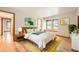 Tastefully staged bedroom filled with natural light and a neutral color palette at 23678 Pondview Pl # D, Golden, CO 80401