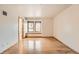 Empty bedroom featuring hardwood floors, natural light from the window, and neutral walls at 23678 Pondview Pl # D, Golden, CO 80401