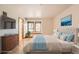 Staged bedroom featuring hardwood floors, lots of natural light, and a light blue color scheme at 23678 Pondview Pl # D, Golden, CO 80401