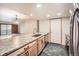 Bright kitchen featuring stone countertops and stainless steel appliances, with an open floor plan at 23678 Pondview Pl # D, Golden, CO 80401