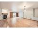 Unfurnished open-concept living room with hardwood floors, fireplace, and sliding glass doors at 23678 Pondview Pl # D, Golden, CO 80401