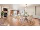 Bright living room featuring a stone fireplace, hardwood floors, and glass dining table at 23678 Pondview Pl # D, Golden, CO 80401