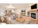 Bright living room featuring hardwood floors, fireplace, and open access to kitchen at 23678 Pondview Pl # D, Golden, CO 80401