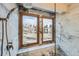Luxurious marble tile shower with dual shower heads and scenic outdoor views from dual windows at 23678 Pondview Pl # D, Golden, CO 80401