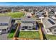 Aerial view of a home with a fenced backyard and patio in a residential neighborhood with mountain views at 16308 Saint Paul St, Thornton, CO 80602