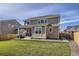 Spacious backyard featuring a lush lawn, patio, and a two-story home with neutral siding at 16308 Saint Paul St, Thornton, CO 80602