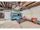 Unfinished basement with an inflatable bouncer, exposed ceiling, and carpeted floor at 16308 Saint Paul St, Thornton, CO 80602