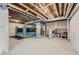 Unfinished basement with an inflatable bouncer, exposed ceiling, and concrete floor at 16308 Saint Paul St, Thornton, CO 80602