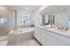 Spa-like bathroom with a soaking tub, walk-in shower, and dual vanities with ample counter space at 16308 Saint Paul St, Thornton, CO 80602