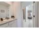 Bright bathroom featuring a tub shower and vanity with a white countertop and decorative plants at 16308 Saint Paul St, Thornton, CO 80602
