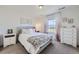 Comfortable bedroom with a large window, neutral decor, and a patterned accent blanket at 16308 Saint Paul St, Thornton, CO 80602