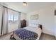 Cozy bedroom with a plush carpet and a large window and great wall art at 16308 Saint Paul St, Thornton, CO 80602