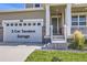 Front entrance with a 3-car tandem garage and a beautiful covered porch at 16308 Saint Paul St, Thornton, CO 80602