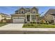 Inviting front yard with lush green grass, a mature tree, and a charming covered porch at 16308 Saint Paul St, Thornton, CO 80602