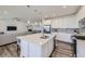 Open-concept kitchen with a large center island and stainless appliances, flowing into the living space at 16308 Saint Paul St, Thornton, CO 80602