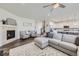 Spacious living room with a fireplace, plush seating, and an open layout to the kitchen at 16308 Saint Paul St, Thornton, CO 80602
