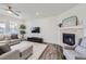 Bright living room featuring a modern fireplace, stylish furniture, and a cozy atmosphere at 16308 Saint Paul St, Thornton, CO 80602