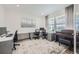 Bright office space with multiple workstations, a large window, and ample natural light at 16308 Saint Paul St, Thornton, CO 80602