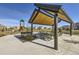 Park picnic shelter with picnic tables next to playground equipment at 16308 Saint Paul St, Thornton, CO 80602