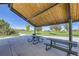 Community pavilion with wooden ceiling, picnic tables, and view of grassy common area at 16308 Saint Paul St, Thornton, CO 80602