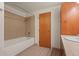 Full bathroom with shower/tub combo and tiled walls at 1800 Lawrence St # 408, Denver, CO 80202