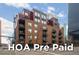 Brick apartment building in downtown with balconies and street-level retail and HOA Pre Paid Text Overlay at 1800 Lawrence St # 408, Denver, CO 80202