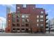 Multi-story brick building, multiple windows and balconies at 1800 Lawrence St # 408, Denver, CO 80202