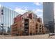 Brick building exterior with multiple balconies and city views at 1800 Lawrence St # 408, Denver, CO 80202