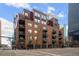 Brick apartment building in downtown with balconies and street-level retail at 1800 Lawrence St # 408, Denver, CO 80202