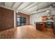 Modern kitchen with exposed brick, hardwood floors, and island at 1800 Lawrence St # 408, Denver, CO 80202