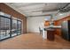 Open concept living room with kitchen, hardwood floors and balcony with city view at 1800 Lawrence St # 408, Denver, CO 80202