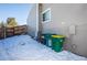 View of backyard with snow, trash cans, and AC unit at 2030 Santana Dr, Castle Rock, CO 80104