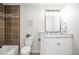 Updated bathroom with a white vanity and brown tile at 2030 Santana Dr, Castle Rock, CO 80104