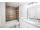 Updated bathroom with a white vanity and brown tile at 2030 Santana Dr, Castle Rock, CO 80104