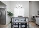 Small dining area with modern table and four gray stools at 2030 Santana Dr, Castle Rock, CO 80104