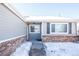 Gray exterior with brick base and snowy front yard at 2030 Santana Dr, Castle Rock, CO 80104