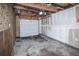 Unfinished garage with overhead door and concrete floor at 2030 Santana Dr, Castle Rock, CO 80104