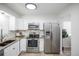 Modern kitchen with white cabinets, granite counters, and stainless steel appliances at 2030 Santana Dr, Castle Rock, CO 80104