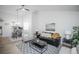 Open living room with black leather sofa and wood floors at 2030 Santana Dr, Castle Rock, CO 80104