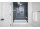 Clean subway tile shower with marble flooring and built-in seat at 2030 Santana Dr, Castle Rock, CO 80104