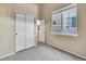 This carpeted bedroom features a bright window, closet, and neutral paint at 1358 Carlyle Park Cir, Highlands Ranch, CO 80129