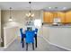 Elegant dining area with a modern chandelier and stylish blue chairs at 1358 Carlyle Park Cir, Highlands Ranch, CO 80129