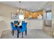 Dining area featuring stylish blue chairs, wood floors, and modern lighting at 1358 Carlyle Park Cir, Highlands Ranch, CO 80129