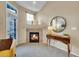 Close up of the tiled fireplace in the living room with natural light from the window at 1358 Carlyle Park Cir, Highlands Ranch, CO 80129