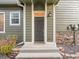 Welcoming front door with sidelight and a decorative welcome mat at 1358 Carlyle Park Cir, Highlands Ranch, CO 80129