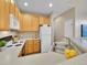 Well-lit kitchen featuring updated appliances, a double sink, and ample counter space at 1358 Carlyle Park Cir, Highlands Ranch, CO 80129