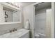 Bright bathroom with a white vanity, marble countertop, and shower with tub combination at 534 E 7Th Ave # 206, Denver, CO 80203