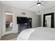 The bedroom has a ceiling fan, mirror, and a glass door leading to a patio at 534 E 7Th Ave # 206, Denver, CO 80203
