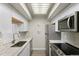 Bright kitchen featuring new appliances, white cabinets, and light countertops at 534 E 7Th Ave # 206, Denver, CO 80203